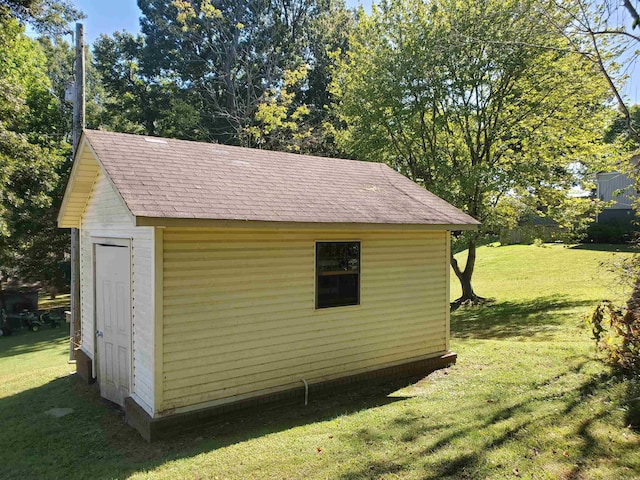 view of outbuilding featuring a yard