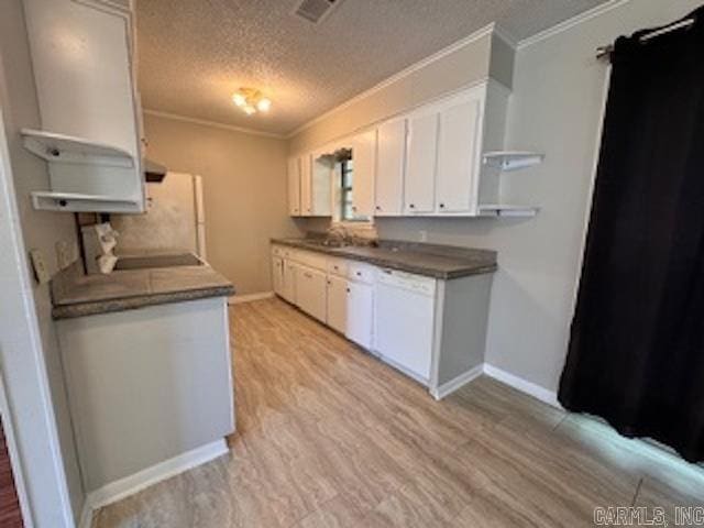 kitchen with a textured ceiling, light wood-type flooring, white cabinetry, and ornamental molding