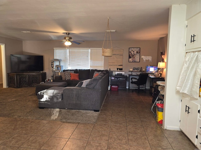 living room with dark tile patterned floors and ceiling fan