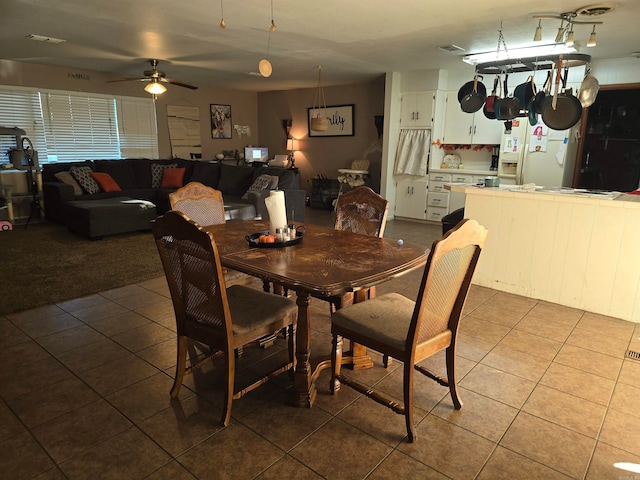 tiled dining space featuring ceiling fan