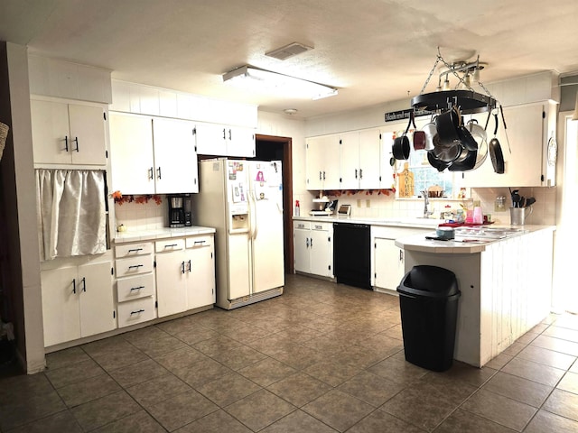 kitchen with white refrigerator with ice dispenser, dishwasher, decorative backsplash, and white cabinetry