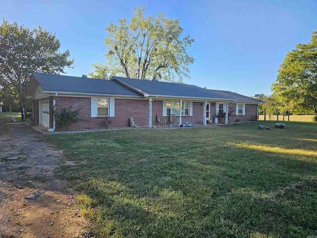 single story home featuring a garage and a front yard