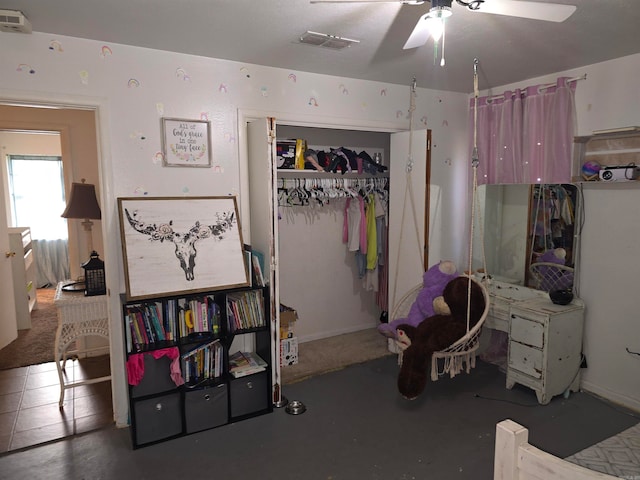 bedroom with ceiling fan and a closet