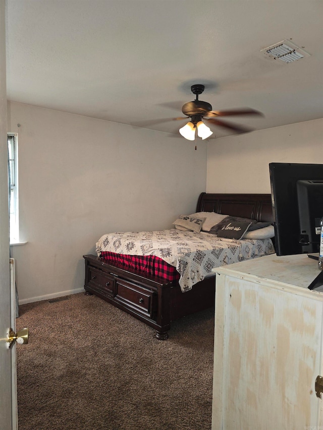 bedroom with dark colored carpet and ceiling fan