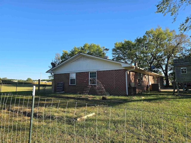 view of side of home featuring a yard