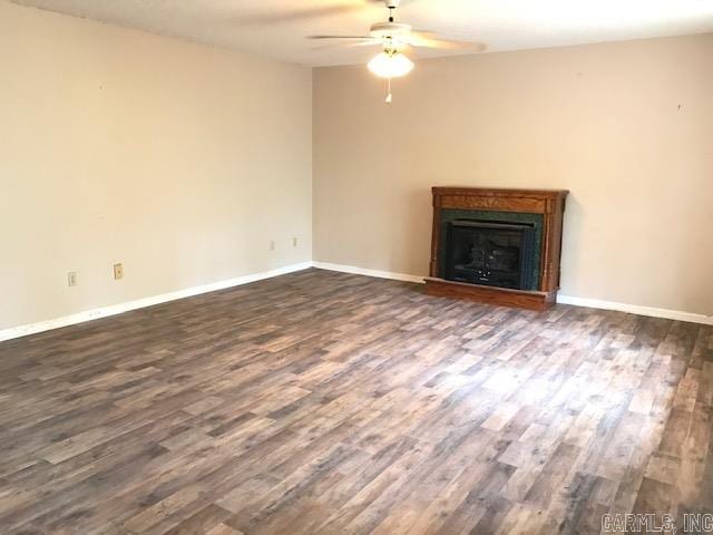 unfurnished living room with ceiling fan and dark hardwood / wood-style flooring