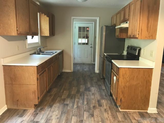 kitchen with dark hardwood / wood-style floors, electric stove, and sink