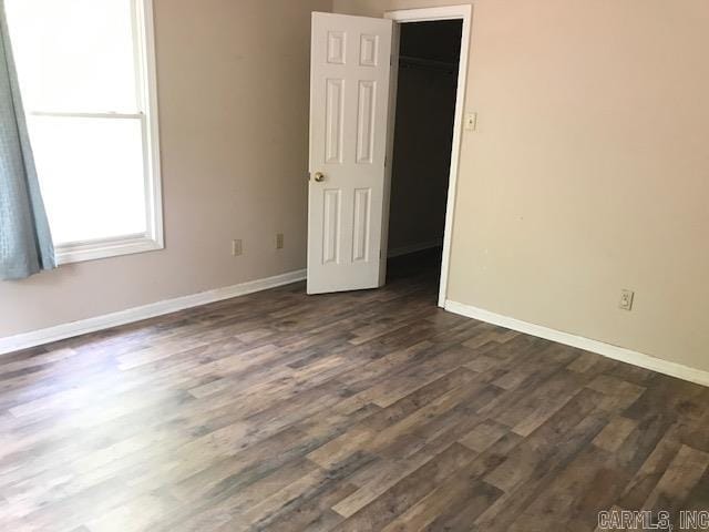 unfurnished room featuring dark hardwood / wood-style flooring