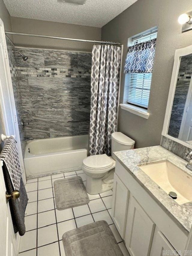 full bathroom featuring vanity, tile patterned flooring, a textured ceiling, and toilet