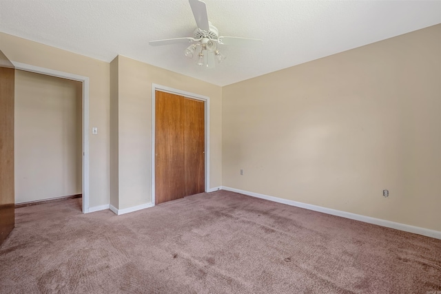 unfurnished bedroom featuring a closet, carpet, ceiling fan, and a textured ceiling