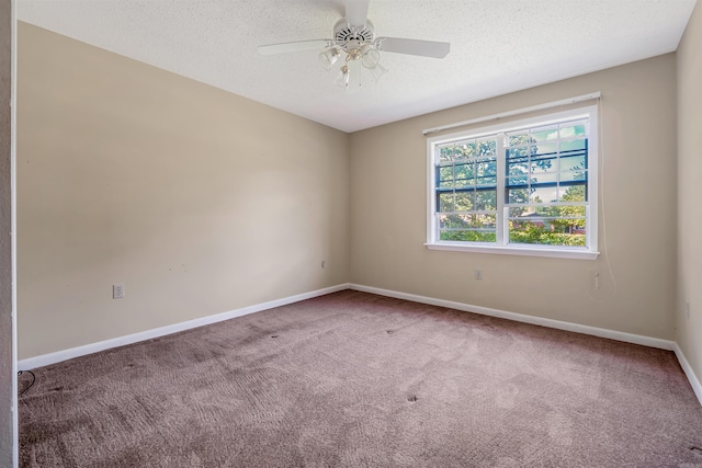 carpeted empty room with ceiling fan and a textured ceiling