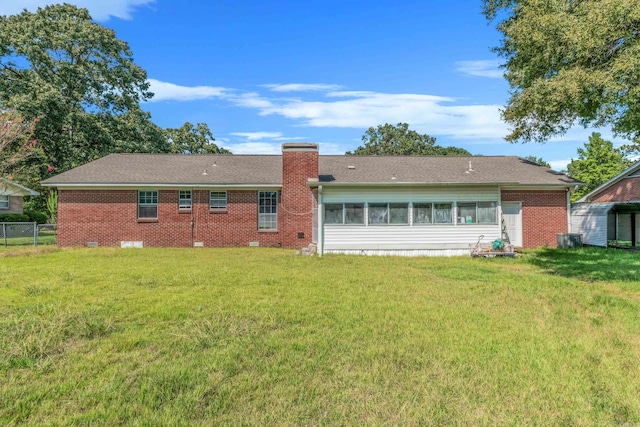 rear view of house featuring a yard