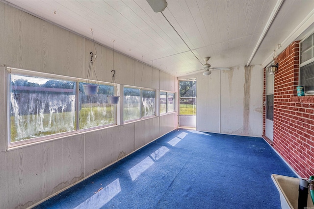 unfurnished sunroom with vaulted ceiling and ceiling fan