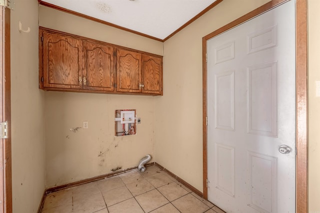 laundry room with hookup for a washing machine, crown molding, light tile patterned floors, and cabinets