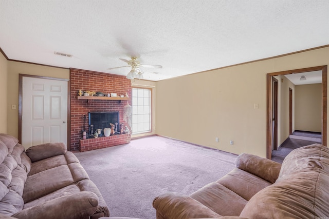 living room featuring ceiling fan, carpet flooring, a textured ceiling, a fireplace, and crown molding