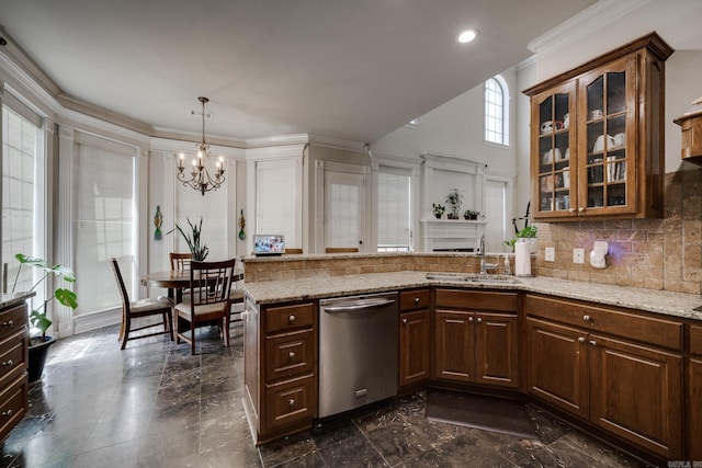 kitchen featuring kitchen peninsula, light stone countertops, dishwasher, sink, and a notable chandelier