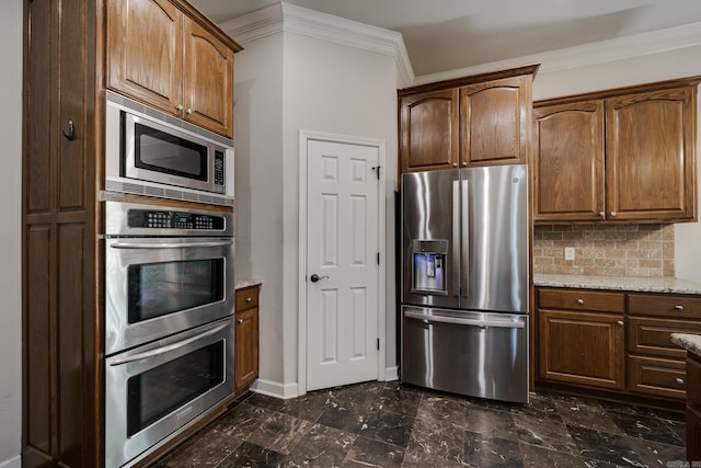 kitchen featuring light stone counters, stainless steel appliances, ornamental molding, and tasteful backsplash