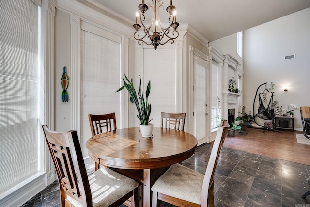 dining space with dark hardwood / wood-style floors, a chandelier, and crown molding