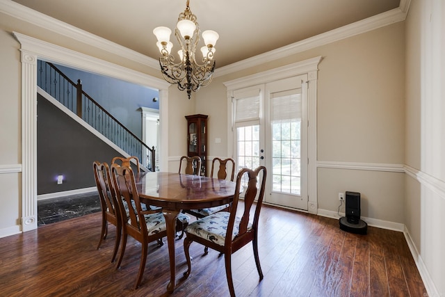 dining room with a notable chandelier, crown molding, french doors, and dark hardwood / wood-style flooring