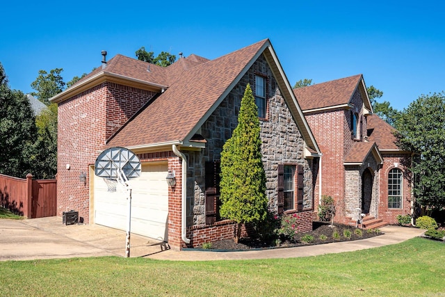 view of front of property featuring a front yard and a garage