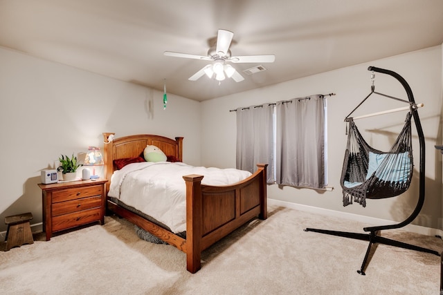 bedroom with ceiling fan and light carpet