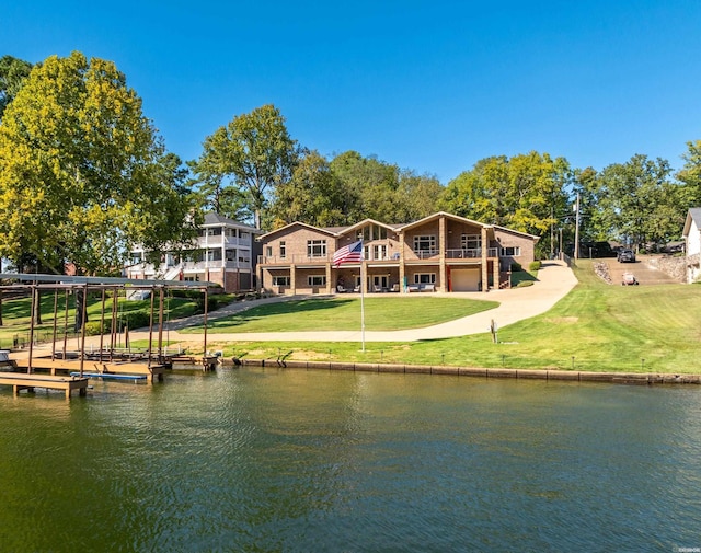 rear view of property featuring a yard and a water view