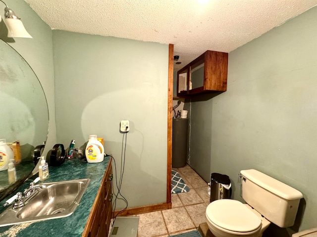 bathroom featuring a textured ceiling, tile patterned flooring, vanity, and toilet