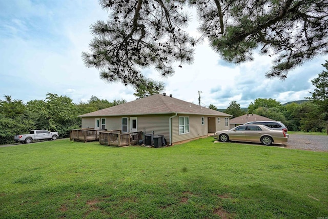 view of property exterior with a wooden deck and a yard