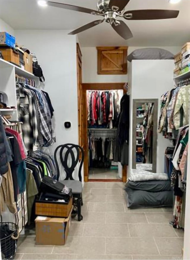 walk in closet featuring light tile patterned flooring and ceiling fan