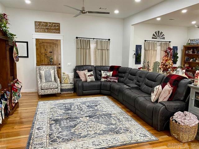 living room featuring ceiling fan and light hardwood / wood-style flooring