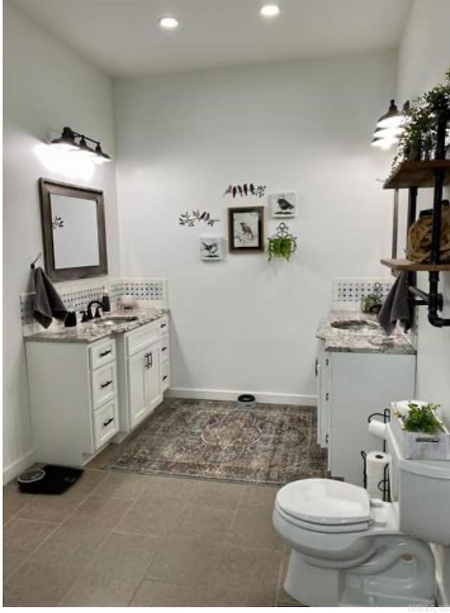 bathroom featuring decorative backsplash, tile patterned flooring, vanity, and toilet