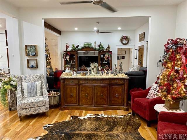 living room with light hardwood / wood-style floors and ceiling fan