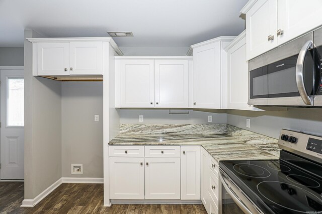 kitchen featuring appliances with stainless steel finishes, white cabinetry, dark hardwood / wood-style floors, and light stone counters