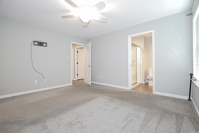 unfurnished bedroom featuring connected bathroom, light carpet, and ceiling fan