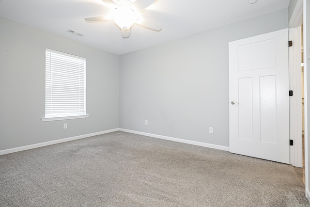 spare room with light carpet and ceiling fan