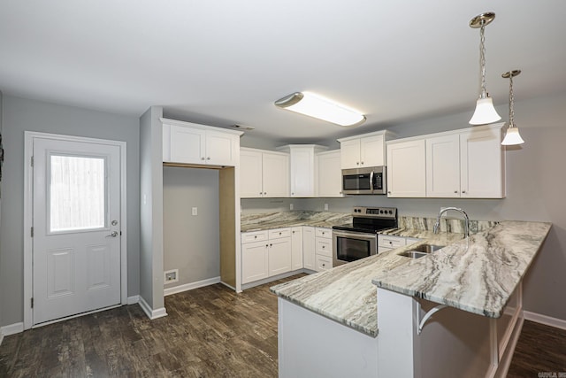 kitchen with sink, decorative light fixtures, white cabinetry, stainless steel appliances, and dark hardwood / wood-style flooring