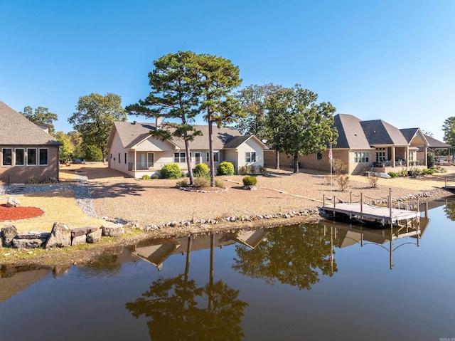 rear view of house featuring a water view