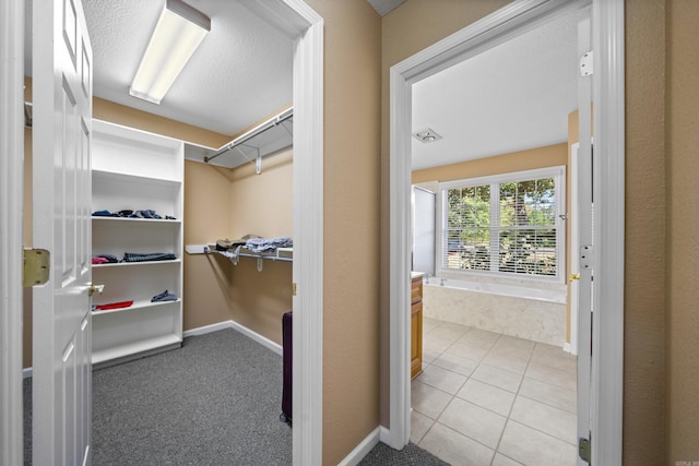 spacious closet with light tile patterned floors