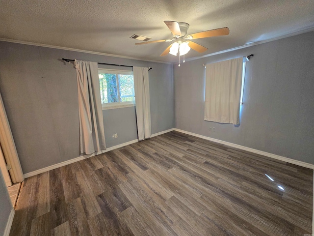 spare room with ceiling fan, a textured ceiling, crown molding, and dark wood-type flooring