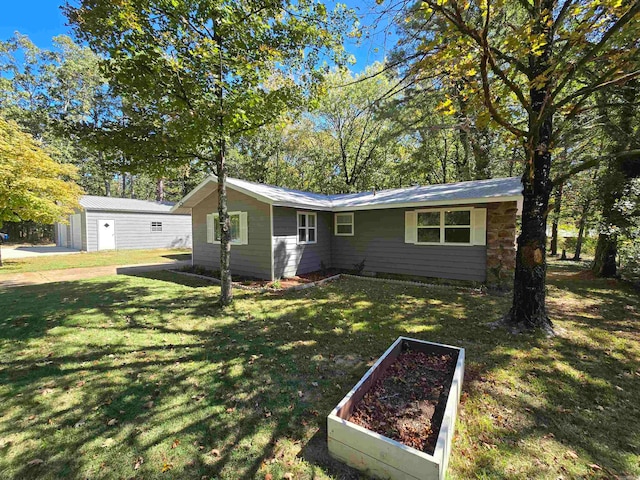 single story home featuring a garage and a front yard