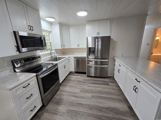 kitchen featuring appliances with stainless steel finishes, white cabinetry, and sink