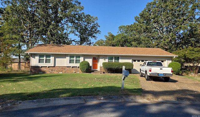 single story home featuring a front lawn and a garage