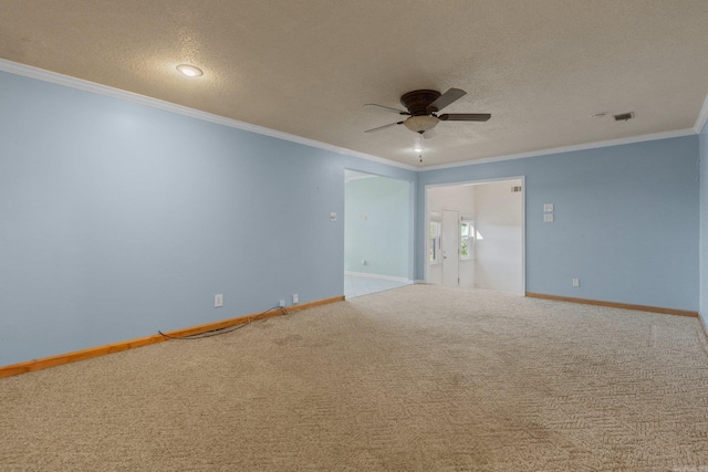 carpeted empty room with ceiling fan, crown molding, and a textured ceiling