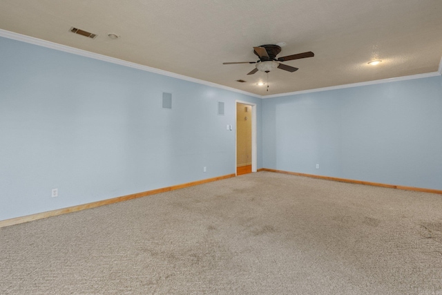 carpeted spare room featuring a textured ceiling, ceiling fan, and crown molding