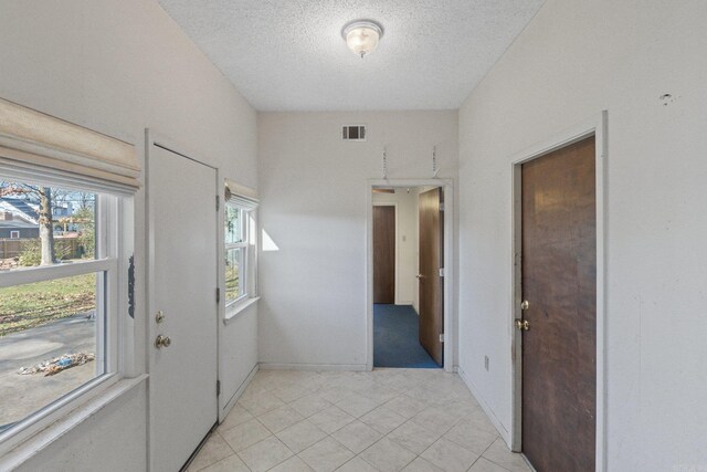 entryway featuring a textured ceiling