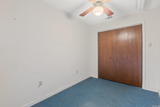 unfurnished bedroom featuring ceiling fan, light colored carpet, and a closet