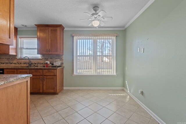 kitchen with decorative backsplash, sink, ceiling fan, and plenty of natural light