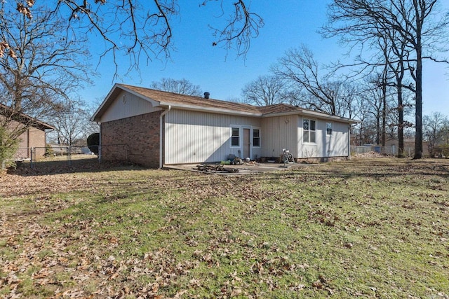 back of property featuring a lawn