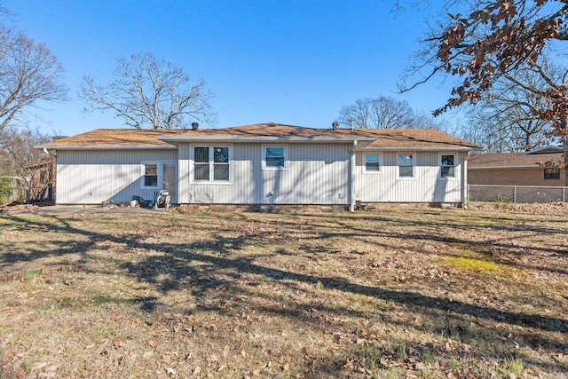 back of property featuring a lawn