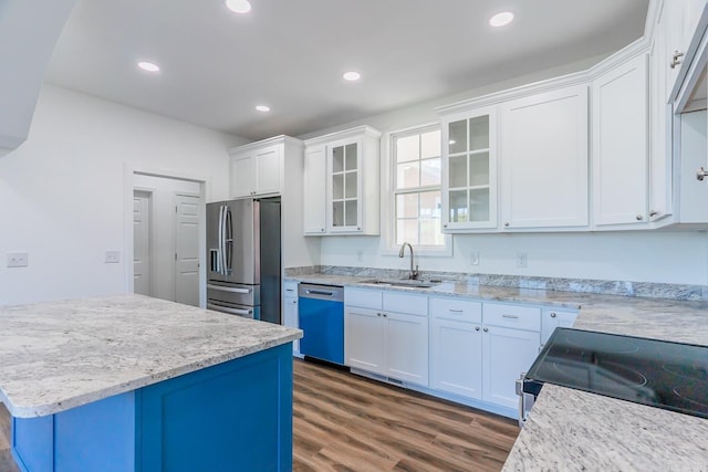 kitchen with light stone counters, dark wood-type flooring, sink, white cabinetry, and appliances with stainless steel finishes